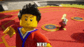 a lego character is standing on a red floor and the word next is on the bottom