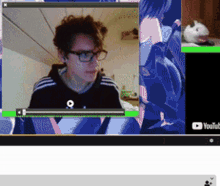 a computer screen shows a video of a man with glasses