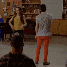 a group of people are dancing in front of a white board that says ' i remember you ' on it