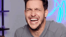 a man with a beard is making a face with his mouth open