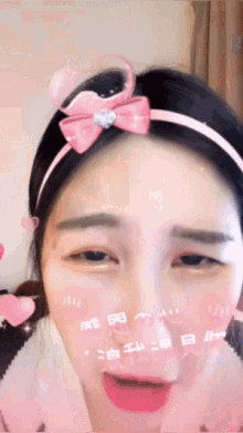 a girl wearing a pink headband with a heart on it