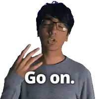 a man wearing glasses and a grey sweater says " go on "