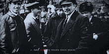 a black and white photo with the words and lenin is young once again in red