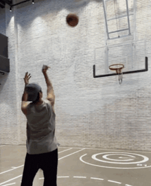 a man is throwing a basketball at a hoop