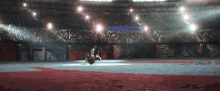a person riding a horse in a stadium with a sign that says ' a ' on it