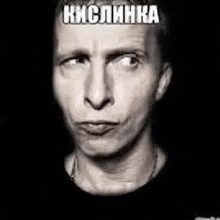 a man 's face is shown in a black and white photo with a foreign language caption .