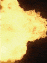a close up of a fireball with smoke coming out of it on a black background