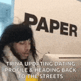 a man in a wig is sitting in front of a wall that says paper .