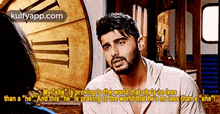 a man with a beard is talking to a woman in front of a clock ..
