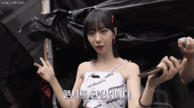 a woman wearing a white top that says vetements