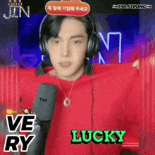 a man wearing headphones and a red shirt with the words lucky written on it