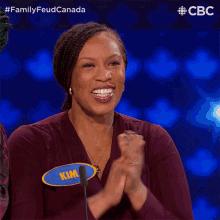 a woman with a name tag that says kim stands in front of a microphone
