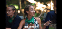 a woman with a green scarf around her neck has the word nije bilo tako above her