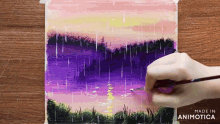 a person is painting a purple and pink landscape with the words made in animatica visible