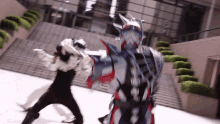 a man in a superhero costume is fighting another person