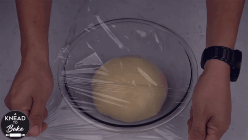covering-the-dough-with-plastic-wrap-a-knead-to-bake.gif
