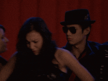 a blurry photo of a man and a woman with the word bass on the strap