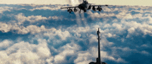 a fighter jet is flying through the clouds with smoke coming out of it