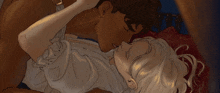 a man and a woman are laying on top of each other on a bed .