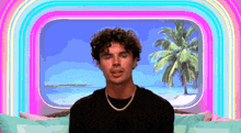 a man with curly hair is looking out a window at a beach