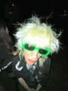 a blurry picture of a person wearing a wig and sunglasses .