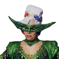 a woman wearing a green mask with a white hat on her head