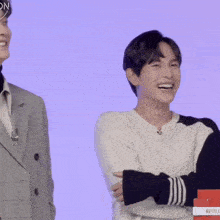 two men are laughing next to a box that says netflix on it