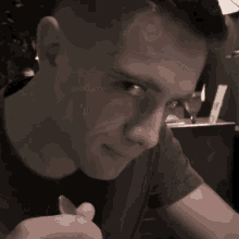 a man is smiling and looking at the camera in a black and white photo