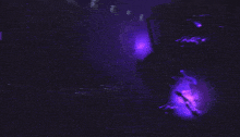 a dark room with a purple light shining on it