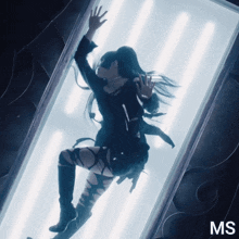 a woman in a black outfit is floating in a glass box with the letters ms on the bottom right