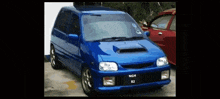 a blue car with a tag that says ngh 82