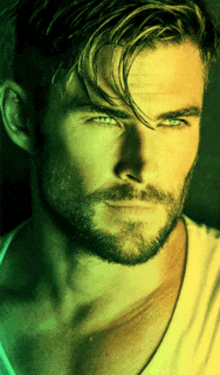 a close up of a man with a beard and blue eyes