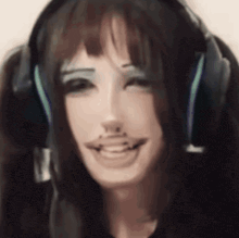 a woman wearing headphones is smiling and making a face .