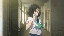 a girl in a school uniform drinking from a bottle