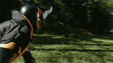 a blurred image of a person wearing a black and orange costume