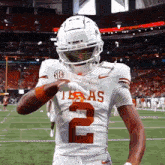 a football player wearing a white jersey with the number 2
