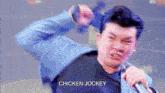 a man singing into a microphone with the word chicken jockey on the bottom