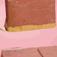 three pieces of chocolate cake are lined up on a wooden table