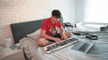 a man is sitting on a bed playing a keyboard that says irig