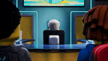 a group of lego figures are sitting in front of a monitor