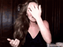 a woman with long hair is covering her face with her hand and the word anahioverdose is on the bottom