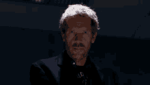 a man with blood on his face is wearing a t-shirt that says old