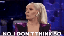 a woman in a ponytail is talking on a stage and says `` no , i don 't think so ''