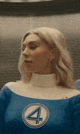 a woman is wearing a blue and white superhero costume with the number 4 on it .