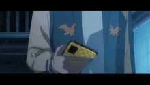 a person in a blue jacket holds a cell phone