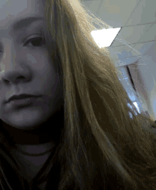 a close up of a girl 's face with long hair