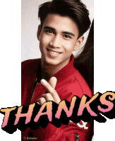 a young man in a red jacket is giving a peace sign and the word thanks is behind him