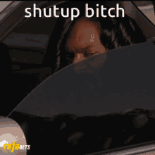 a picture of snoop dogg in a car with the words shut up bitch above him