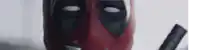 a close up of a deadpool bottle with a knife in front of it .