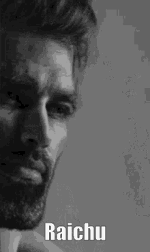 a black and white photo of a man with a beard and the words raichu written on it .